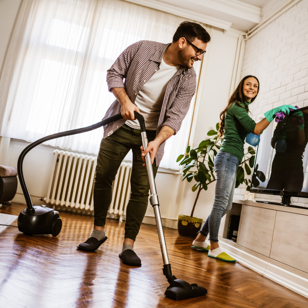 Happy couple cleaning their come Happy couple cleaning their come